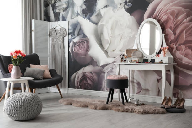 istock Stylish room interior with elegant dressing table, sofa and floral wallpaper 1342054138