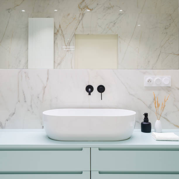istock Stylish bathroom washbasin and blue drawers 1342054706