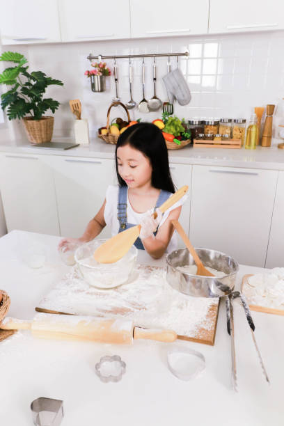 istock Close up single little sister make a bake in the kitchen 1342055034