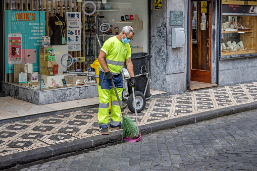 Street cleaner at work in the center of the Portuguese Azorean Island San Miguel in the middle of the North Atlantic Ocean
