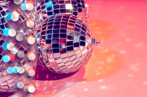 disco ball bauble on pink background. party concept