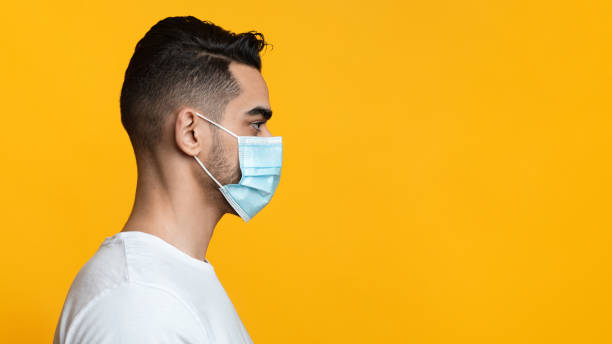 istock Profile portrait of arab guy with face mask 1342056163