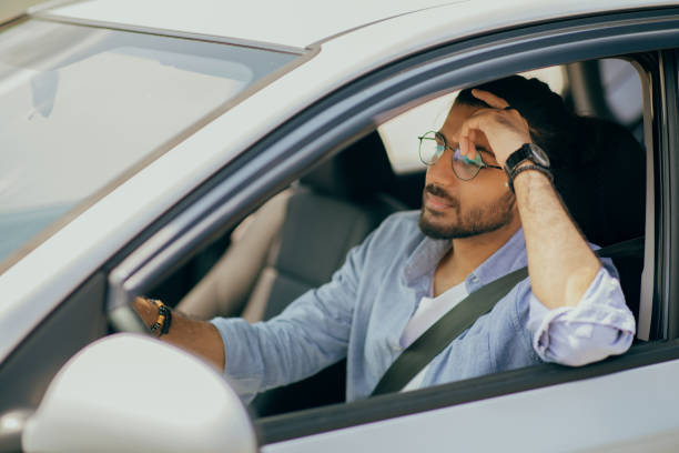 istock Arab guy driving nice car, dreaming while stuck in traffic 1342056185
