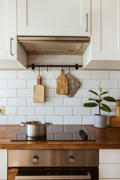 istock Boiling water in a cooking pot an a pan on a induction stove in the modern white kitchen 1342057892