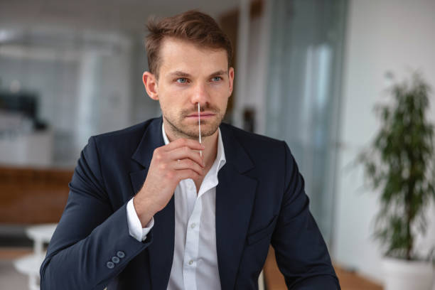 istock Manager taking a self-swabbing test for COVID-19 in his office 1342057998