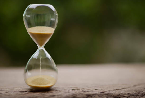 istock Sand clock , Hourglass as time passing on green nature background , Life time concept 1342058281