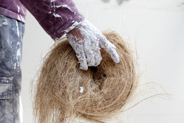 istock Plaster dirty hand with hemp for plasterboard 1342059172