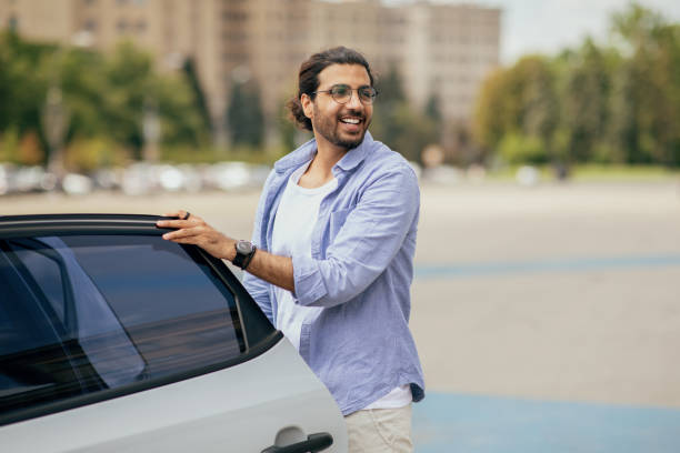 istock Stylish handsome middle-eastern man getting in white car 1342061942