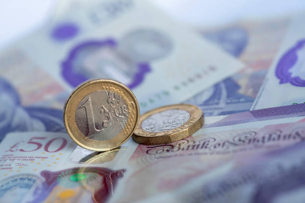 istock One pound coins and one euro coin. 1342062139