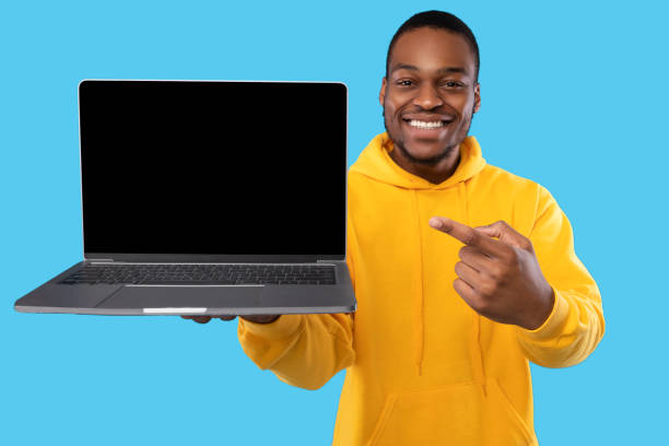 istock African American Guy Showing Laptop Empty Screen Over Blue Background 1342063332