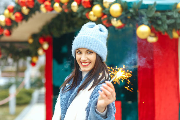 istock Surprised lady enjoying holidays with sparklers 1342064168
