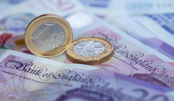 istock One pound coins and one euro coin. 1342064870