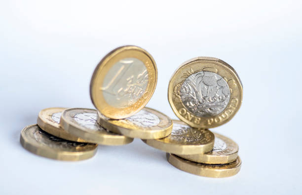 istock One pound coins and one euro coin. 1342064966