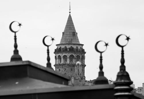 Istanbul, Turkey - July 11, 2023: Galata Tower was built by the Byzantine Emperor Anastasius as a lighthouse in 528, but the Genoese rebuilt the tower in 1349. The tower, which was damaged by the earthquake in the 1500s, was repaired by Architect Hayreddin. III. During the Selim period, a bay window was added to the upper floor of the tower. When the tower suffered another fire in 1831, II. Mahmut climbed two more floors above the tower. Finally restored again in 2020