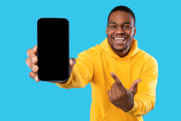 istock African Man Showing Cellphone With Blank Screen Over Blue Background 1342066049