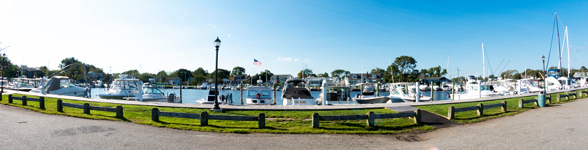 Fisheye panorama view of a marina full of boats in Babylon Village New York on a sunny late summer morning.