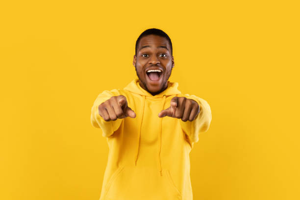 istock Excited African American Guy Pointing Fingers At Camera, Yellow Background 1342067244