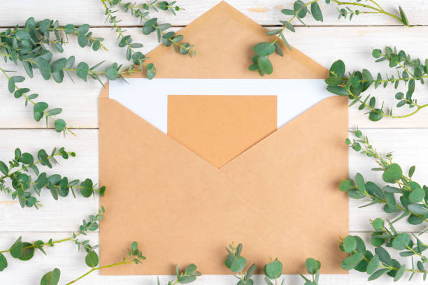 istock Empty letter with copy space surrounded by floral branches on wooden rustic background 1342067738