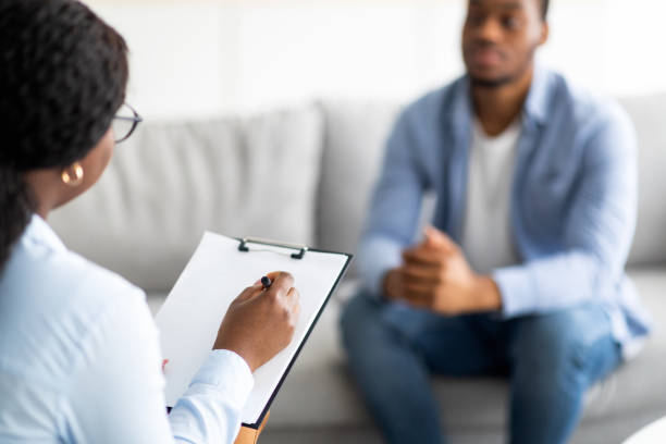 istock Young black guy with depression or PTSD having session with psychotherapist at clinic, selective focus 1342068678