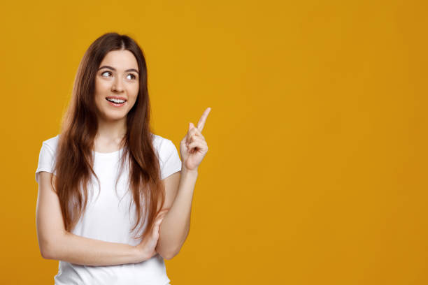 istock Interested young lady pointing at copy space 1342068750