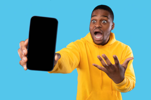 istock Emotional Black Guy Showing Smartphone With Empty Screen, Blue Background 1342068764