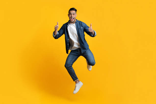 istock Emotional arab guy jumping up and showing thumbs up 1342070718