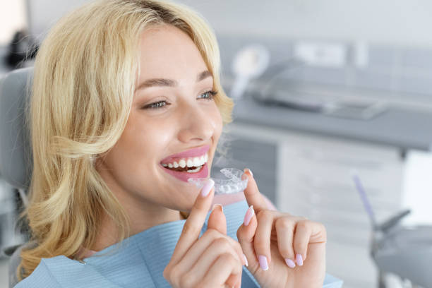 istock Young attractive woman holding invisible braces or trainer 1342070752