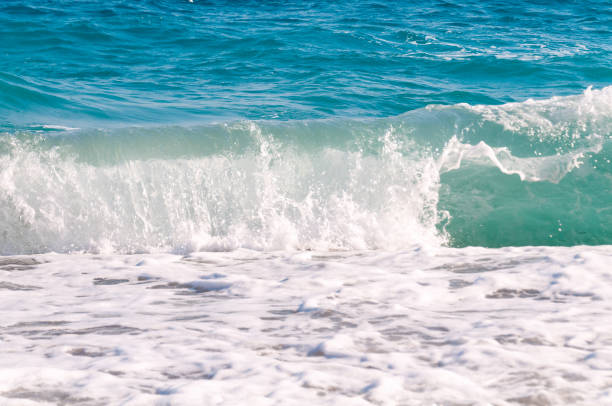 istock beautiful surf waves near the sandy beach on a clear summer da? 1342071512