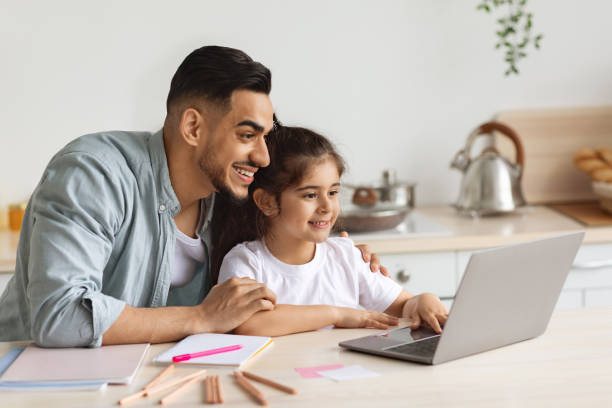 istock Happy arab single father helping daughter with homework 1342071902