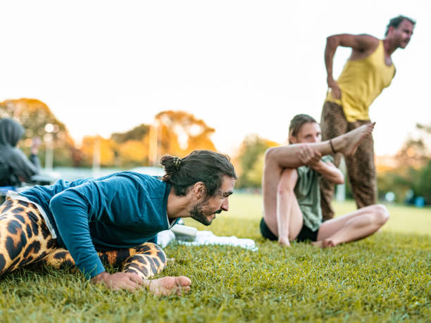 istock People practising Acro Yoga in the park 1342071910