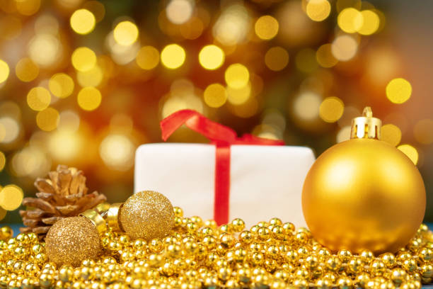 istock Xmas baubles on wooden table on bokeh background 1342072234