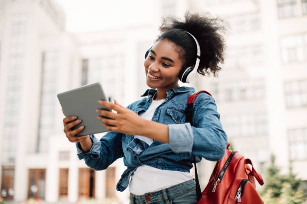 istock African Female Student Girl Video Calling On Tablet Computer Outside 1342072301