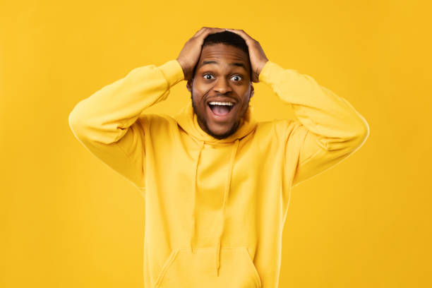 istock Excited Black Guy Shouting Touching Head Standing On Yellow Background 1342072946