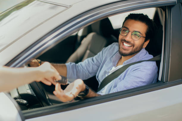 istock Cheerful arab man taking car key from leasing service employee 1342072981