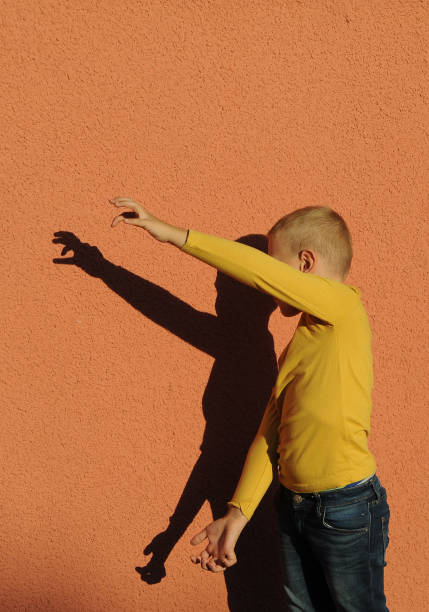 istock little boy playing shadow theater 1342073587