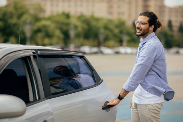 istock Cheerful middle-eastern man in casual getting in taxi 1342074884