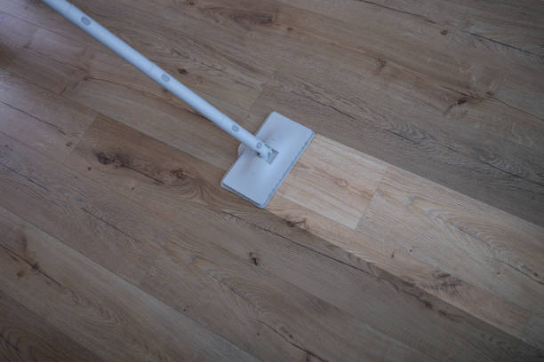 istock Cleaning wood floor with mop over view 1342075713