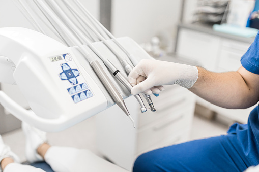 Dentist preparing intervention with dental turbine