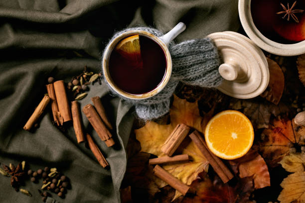 istock Hot mulled wine with spices and autumn leaves 1342077309