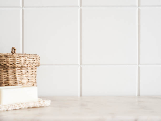 istock Bath background front view with straw box and white soap on white marble shelf 1342077495