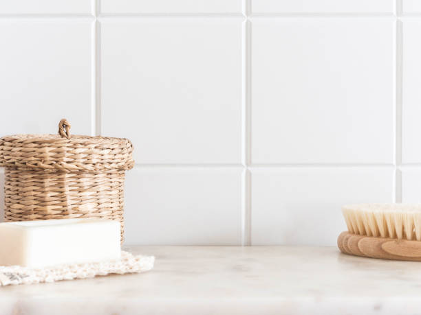 Bath background front view with straw box, wood brush for body and white soap on white marble shelf Bath background front view with straw box, wood brush for body and white soap on white marble shelf and wall tiles. Front view. Copy space nature russia environmental conservation mineral stock pictures, royalty-free photos & images