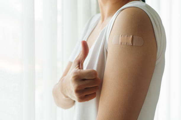 istock Healthy woman thumb up after getting vaccinated immunity, vaccination, vaccinated patient, vaccine roll-out program 1342077519