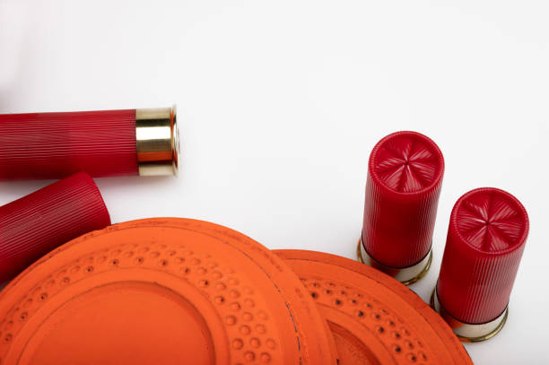 istock Clay shooting target with shotgun shells on white isolated background , Shotgun game 1342081932