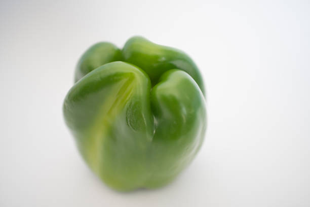 Close up of a fresh green pepper with white background