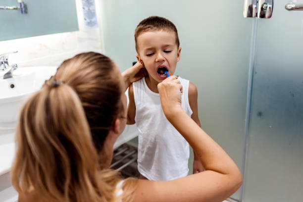 istock Mother teaching her son how to bush teeth 1342082520