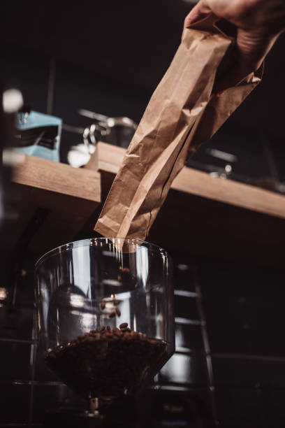 istock Coffee beans are poured from the bag into the grinder 1342082607