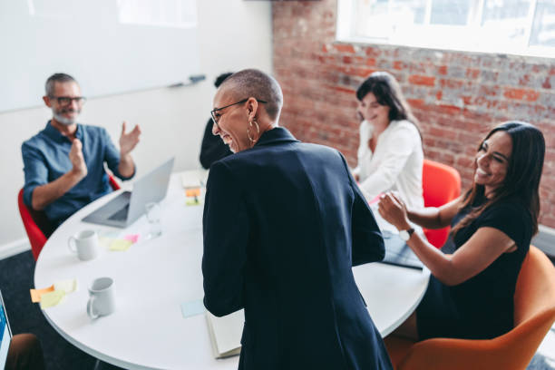 istock Woman being applauded by her team in an office 1342086458