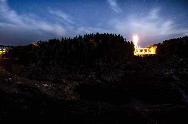 istock Shawinigan illuminated dam during summer night with stars 1342088001
