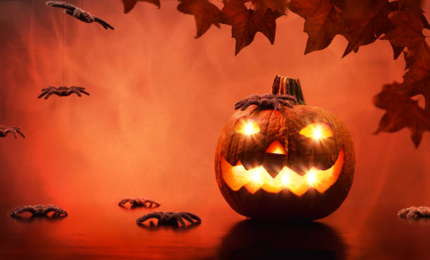 istock Halloween pumpkin with spiders and red fire background 1342088107