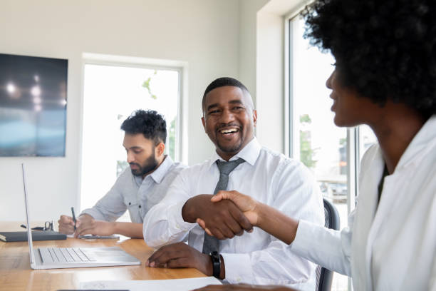 istock Coworkers greeting each other in office meeting 1342088264